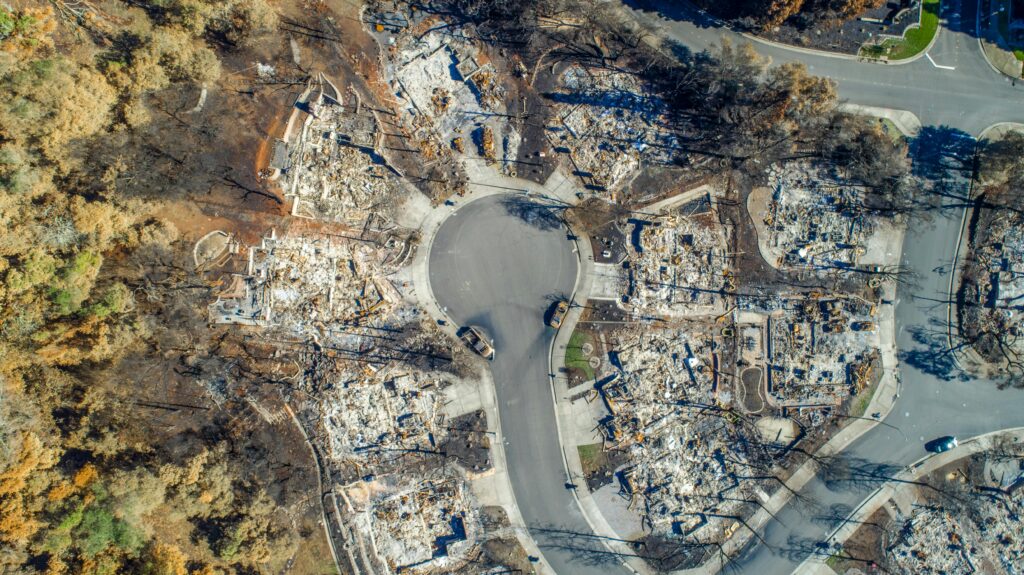 Aerial view of Santa Rosa neighborhood devastated by Tubbs Fire. Burned homes visible.