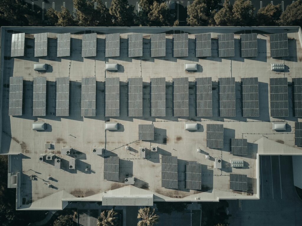 Discover the efficiency of solar energy with this aerial shot of solar panels on a rooftop.