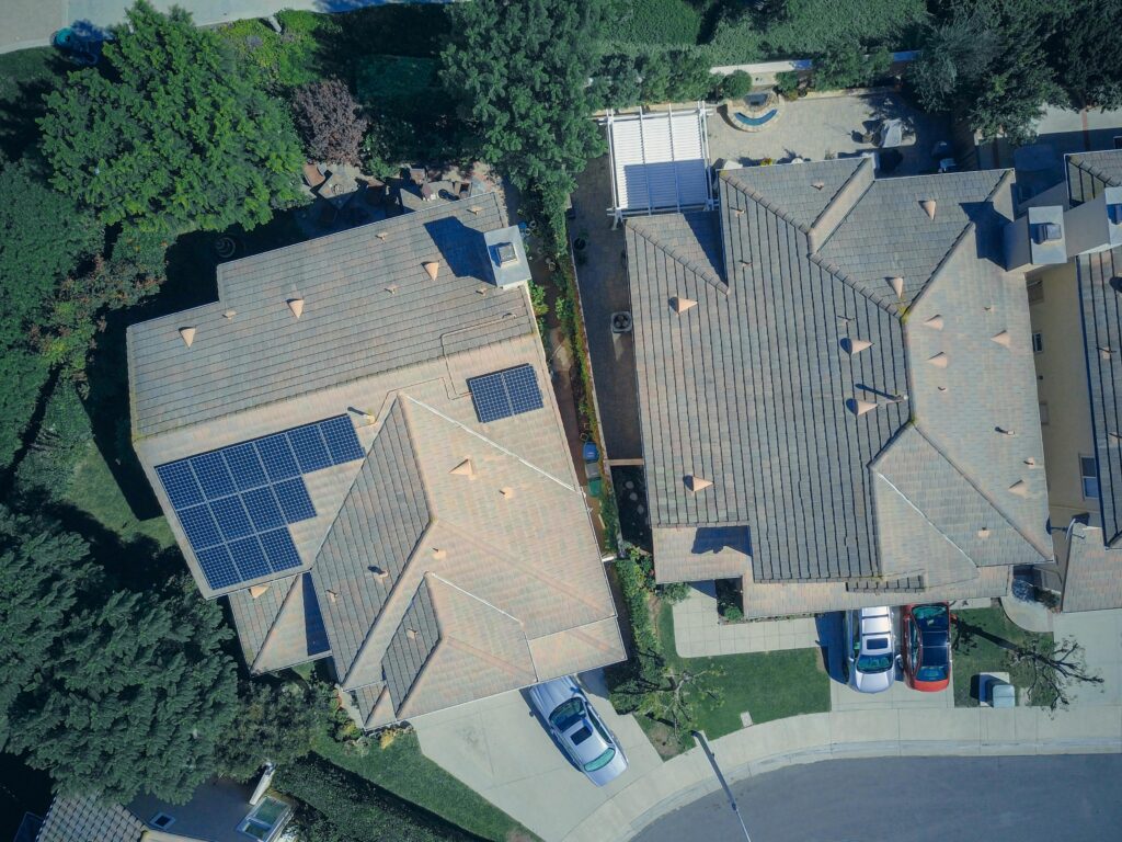 Top view of houses with solar panels, showcasing clean energy and sustainability.